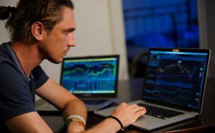 man sitting in front of the MacBook Pro